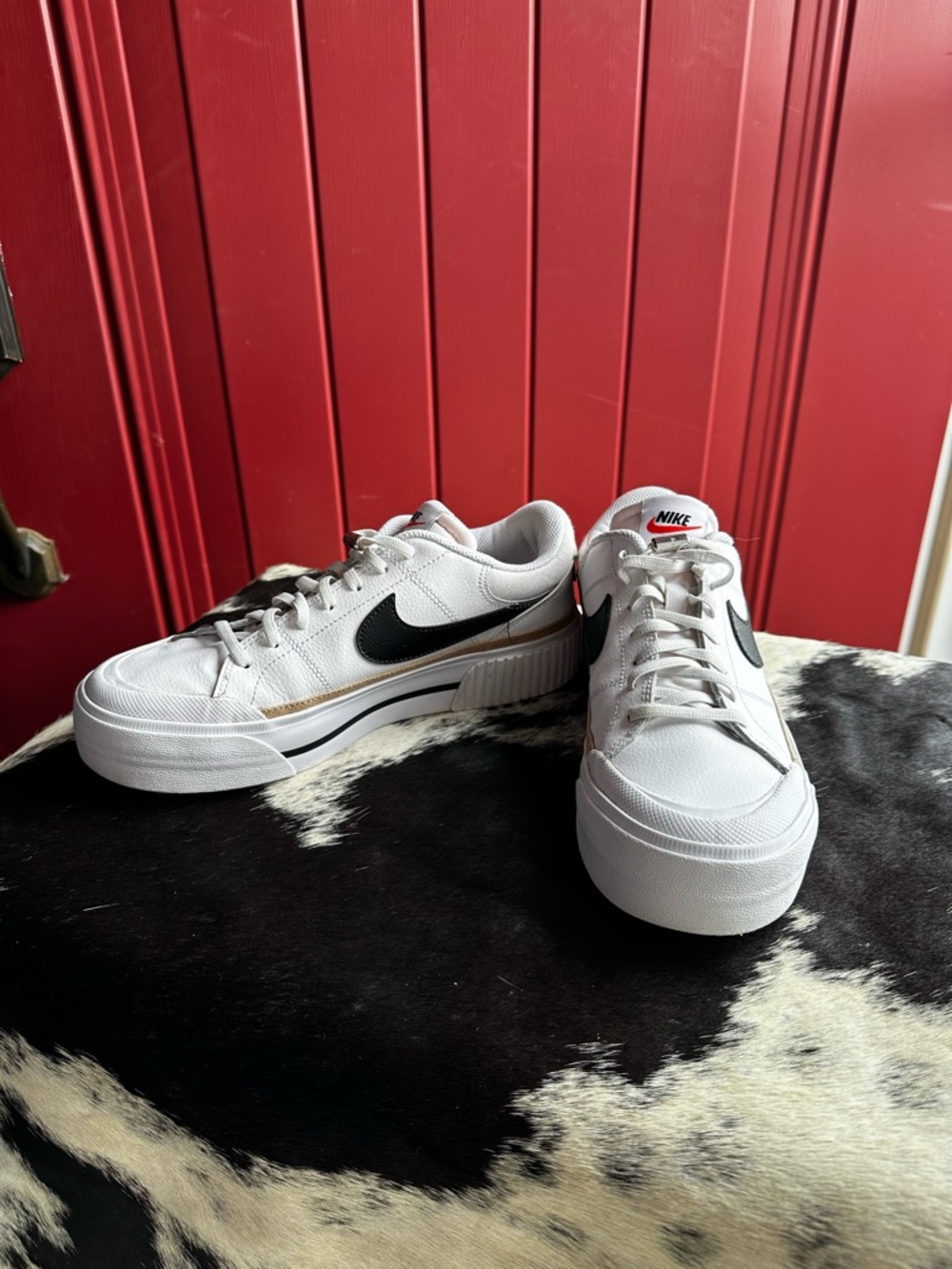 Nike White Low-Top Sneakers with Black Swoosh and Gold Trim